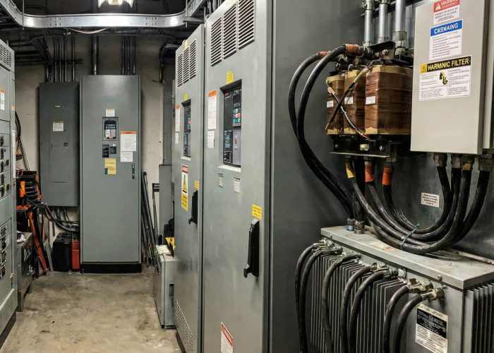 Electrical room with multiple HVAC variable frequency drives and external output and harmonic filters