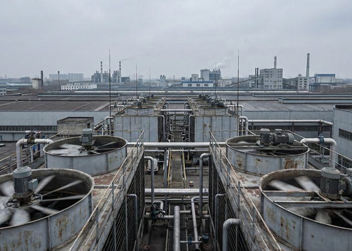 Rooftop cooling towers and HVAC equipment operating on a large industrial or commercial facility